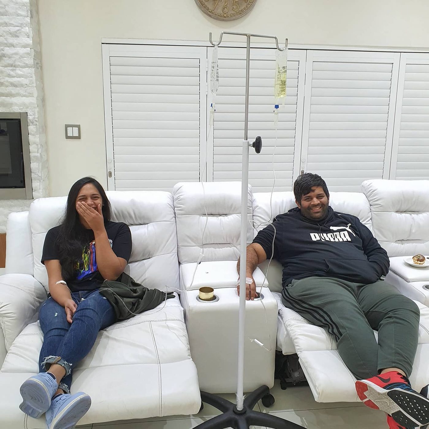 Patients seated in a white clinic lounge