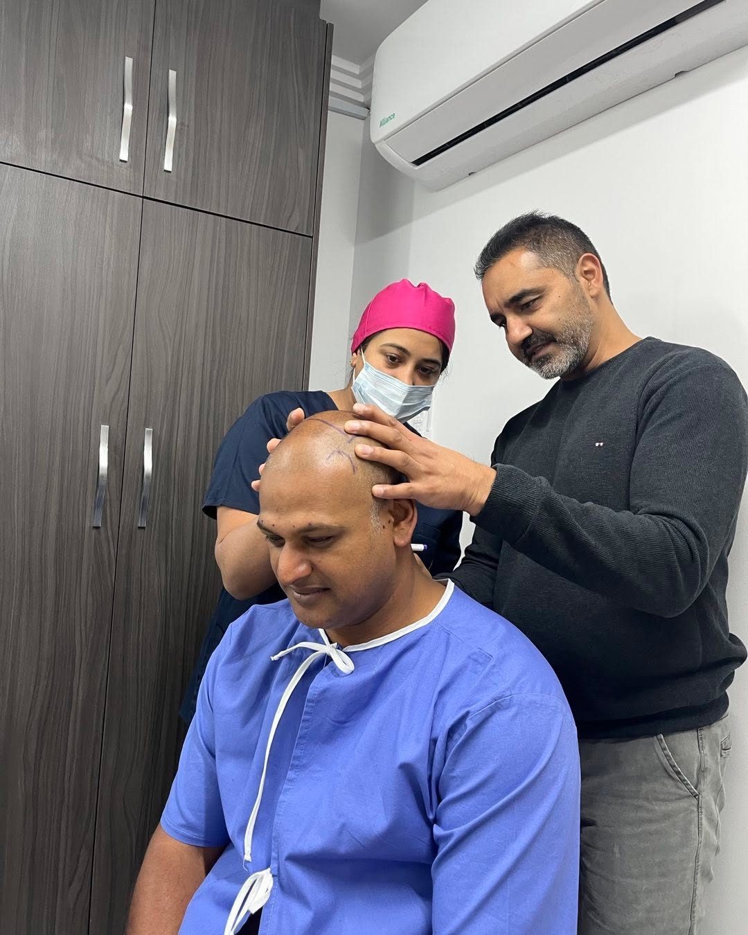 Dr M Kader guiding a hair restoration consultation